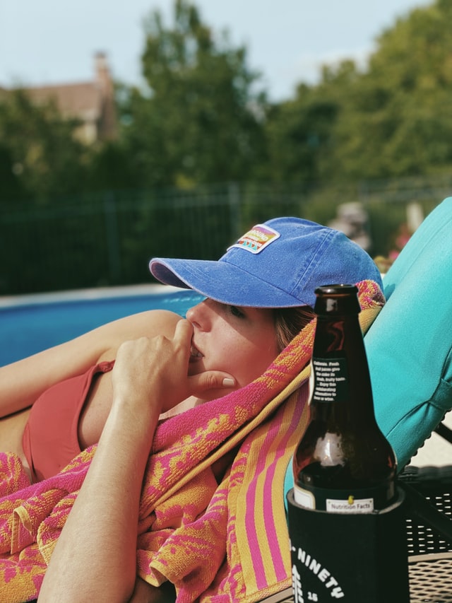 Lounge by the pool with a summer beach towel and refreshing drink.