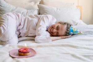 Enjoy a birthday breakfast in bed with a candle and party hat to celebrate your quarantine birthday at home